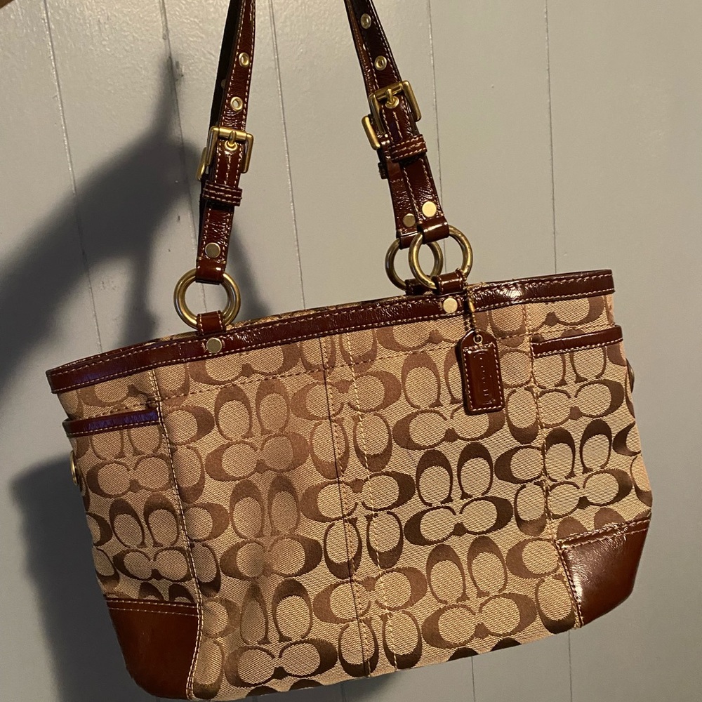 Medium sized coach purse with a small red mark inside as pictured